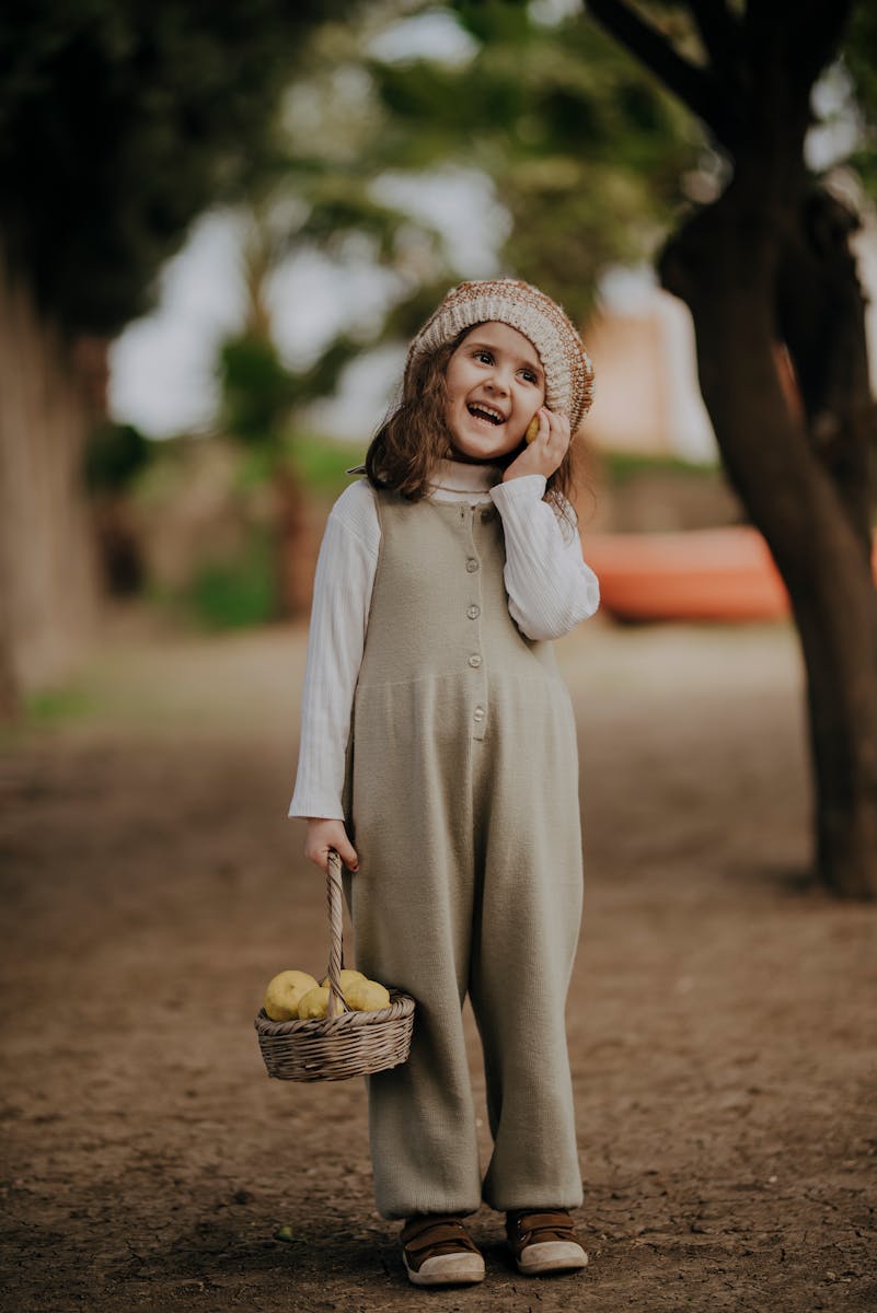 Cheerful child playing outdoors with fruit basket in Hatay, Türkiye.