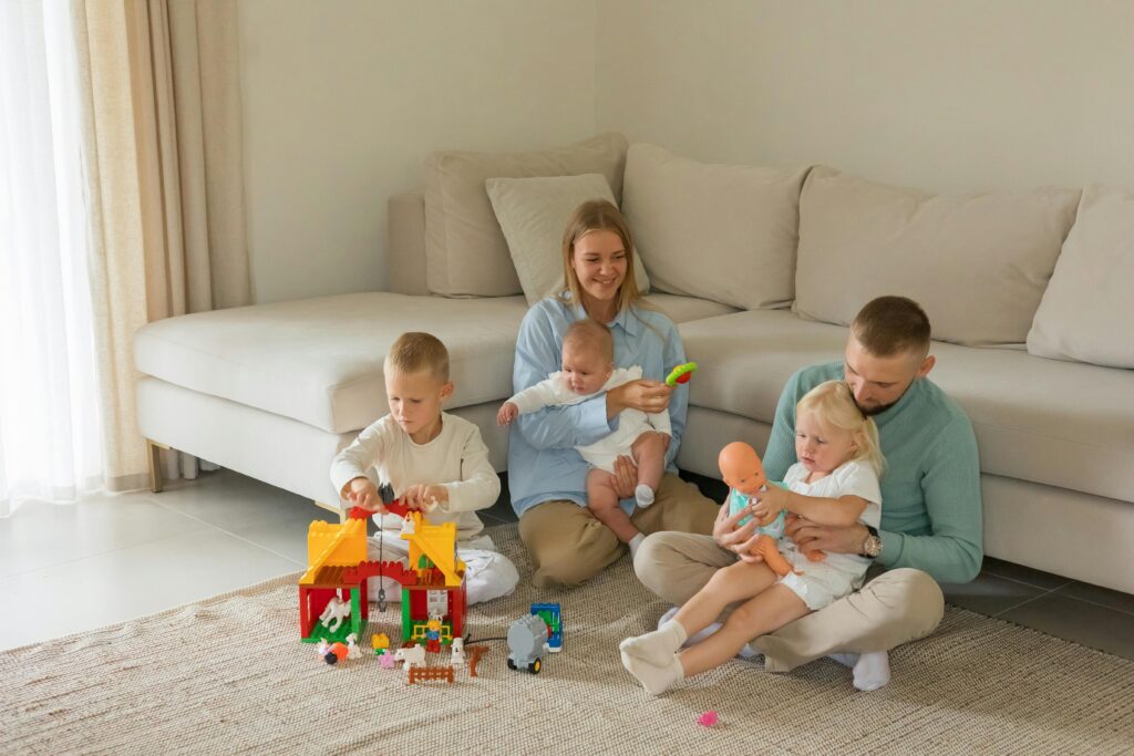 SEO for Toy Stores: How to Grow Organic Traffic and Sales 3 A cheerful family enjoying playtime with toys in a modern living room setting.