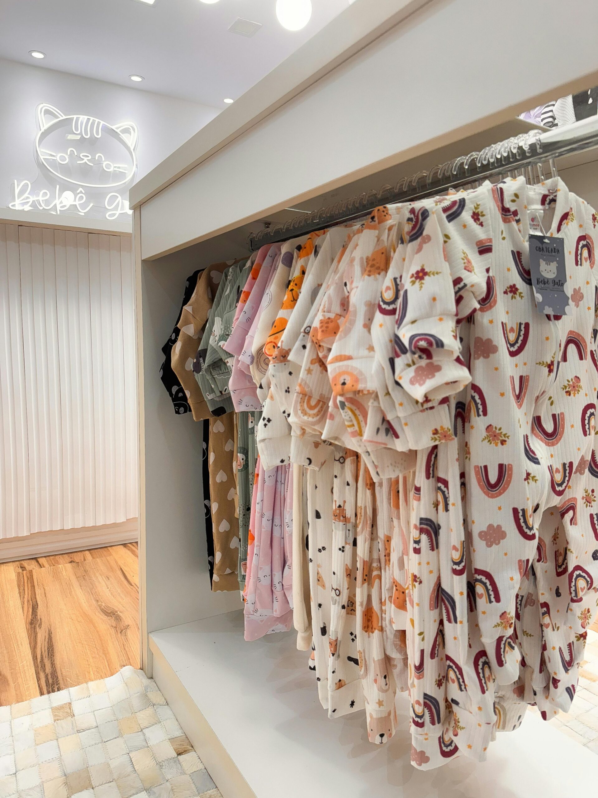 Charming display of colorful baby clothes in a modern retail store setting.