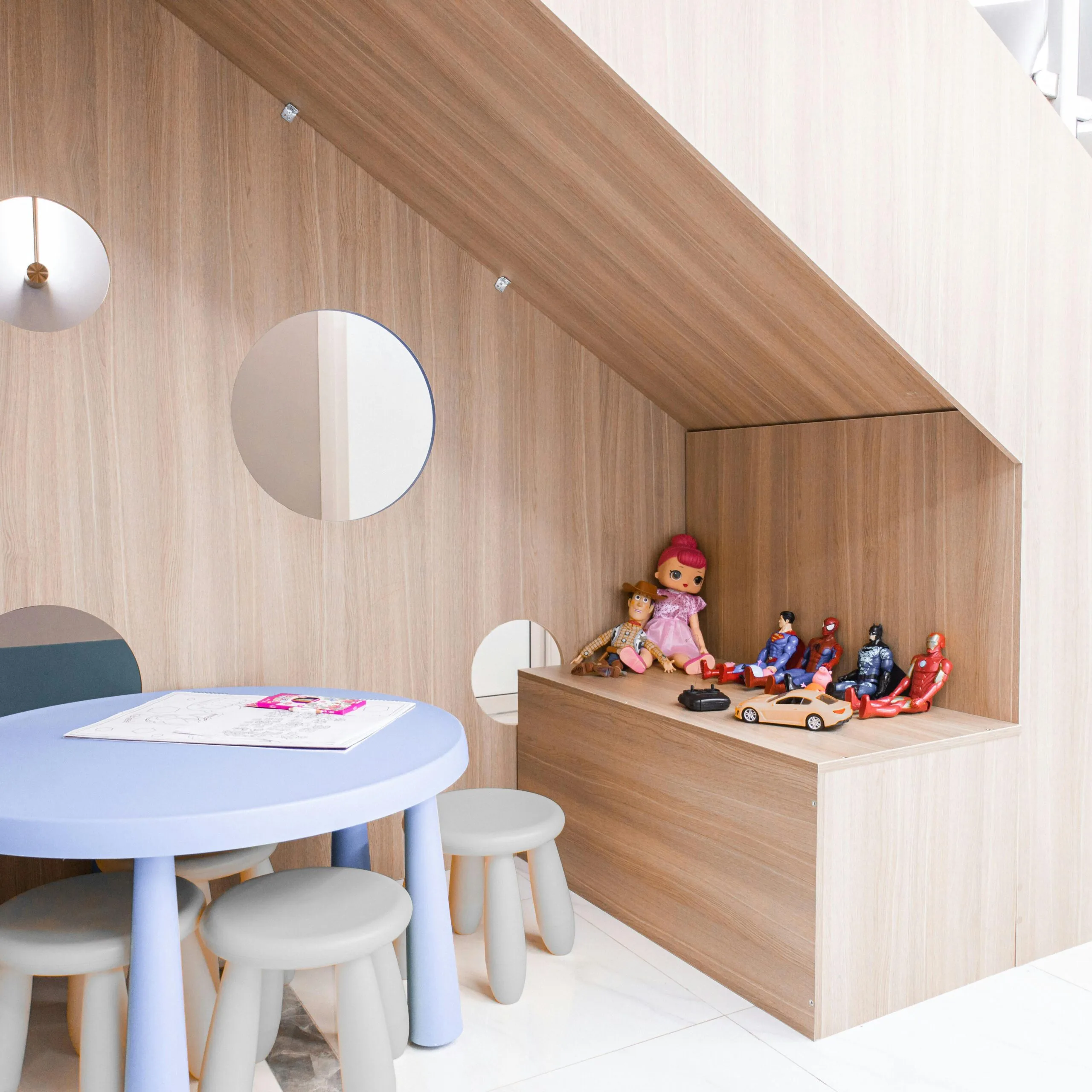 Who we help 4 A stylish playroom with round table, stools, and toys, ideal for modern preschools.