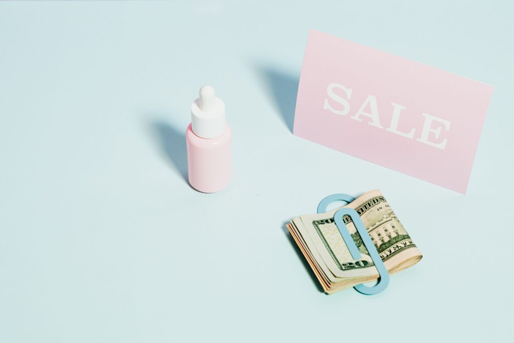 How Baby Brands Should Use Educational Content Before Product Promotion 2 Aesthetic flat lay of a sale sign with US dollars and skincare product. Perfect for sales promotions.