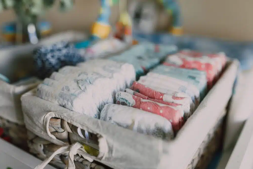 How to Market Baby Products Without Sounding Generic 2 Close-up of neatly arranged colorful baby diapers in a woven basket, ideal for nursery organization.