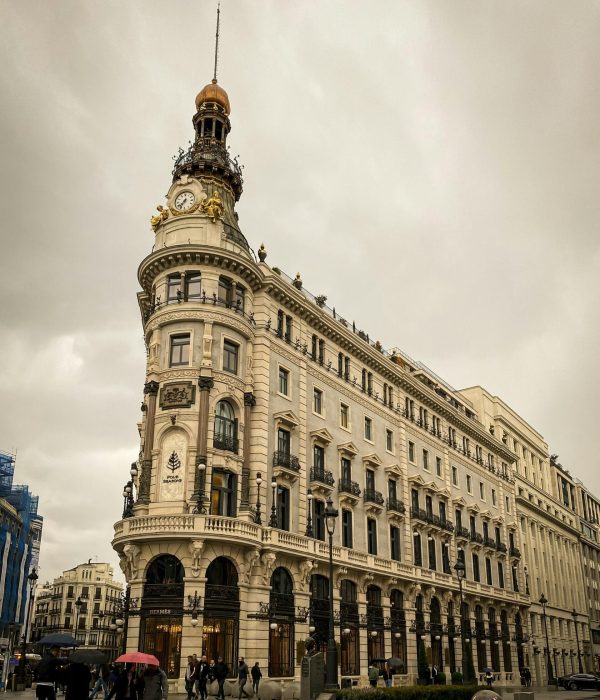 View of a historic building with clock tower in Madrid, ideal for travel and architecture themes.