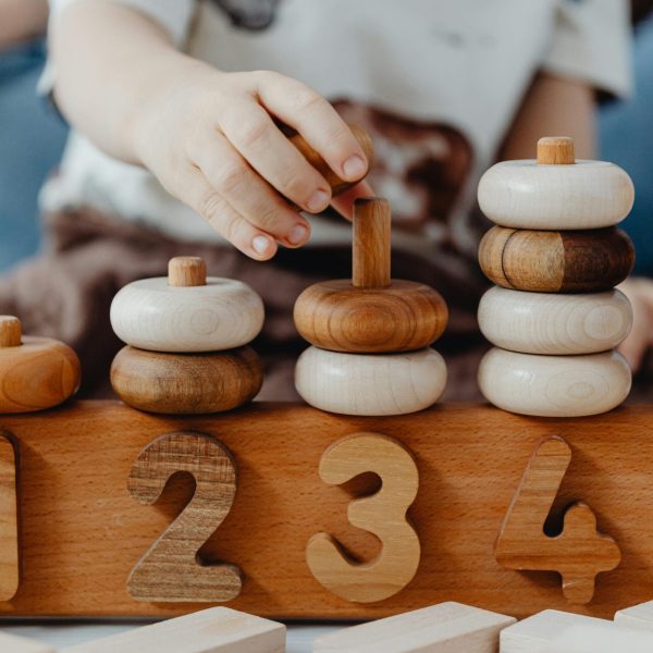 A child interacts with educational wooden number blocks, enhancing cognitive skills.